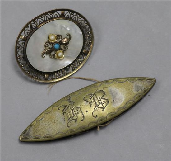 A mother of pearl brooch and a silk winder